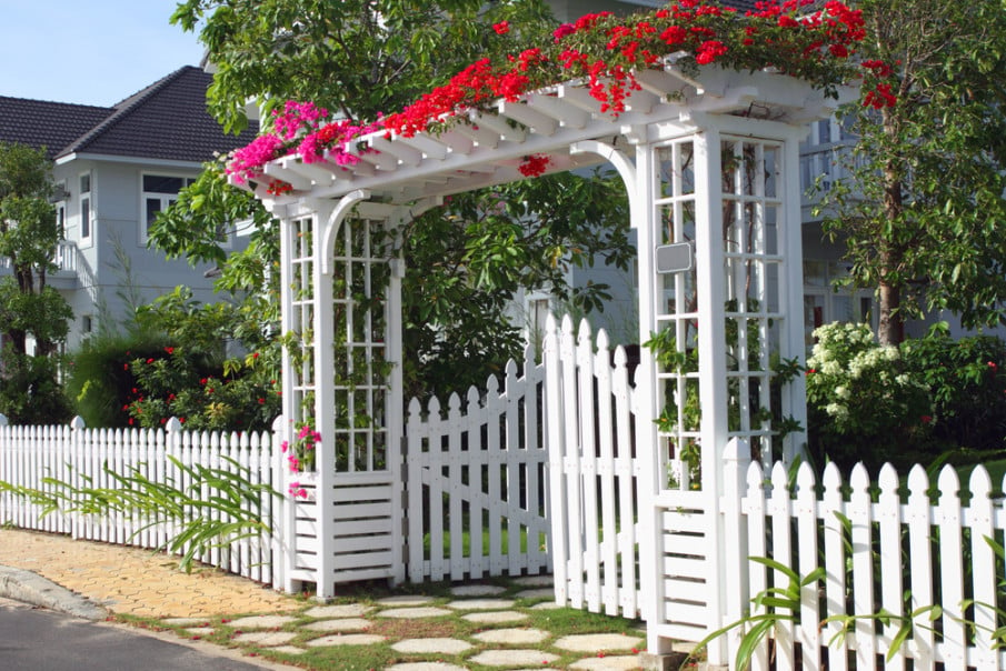 Amazing ideas of a pergola arbor over white gate covered with flowers