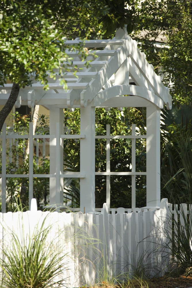 Pergola roof arbor with gate and matching white fence